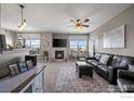 Inviting living area featuring a fireplace, comfortable seating, and lots of natural light at 2800 Blue Sky Cir # 208, Erie, CO 80516
