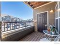 Private balcony with a small table and chairs offering a relaxing outdoor space with neighborhood views at 3100 Blue Sky Cir # 205, Erie, CO 80516
