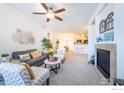 Open concept living room with fireplace and view to kitchen offers modern living at 3100 Blue Sky Cir # 205, Erie, CO 80516