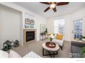 Inviting living room features a cozy fireplace and comfortable seating area with a ceiling fan at 3100 Blue Sky Cir # 205, Erie, CO 80516