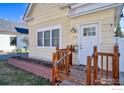 Inviting front porch with wooden railings and a charming front door at 324 Francis St, Longmont, CO 80501