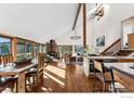 Bright living room with wood floors, vaulted ceilings, a stone fireplace, and natural light from surrounding windows and a skylight at 333 Antler Dr, Boulder, CO 80302