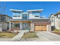 Contemporary two-story home boasts a stylish facade with a covered porch and a two-car wooden garage at 3633 Paonia St, Boulder, CO 80301