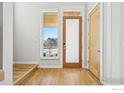Bright foyer with hardwood floors, stylish door, and a large window offering natural light and neighborhood views at 3633 Paonia St, Boulder, CO 80301