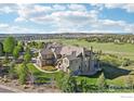 Expansive aerial view showcasing the home's location on a sprawling lot with mature trees and neighborhood views at 4873 Desperado Way, Parker, CO 80134