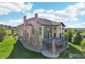Aerial image of the home's backyard with stone accents, a deck, patio and lush landscaping creating privacy at 4873 Desperado Way, Parker, CO 80134