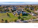 Expansive backyard with mature trees and lush lawn surrounding a beautiful two-story home at 6006 E 162Nd Pl, Brighton, CO 80602
