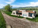 Charming home with a detached garage surrounded by lush greenery and mature trees at 8602 N 39Th St, Longmont, CO 80503