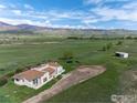Aerial view of a quaint home with a large lot and a storage shed on a green field at 8602 N 39Th St, Longmont, CO 80503
