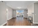 Bright living room featuring a fireplace, hardwood floors, and a sliding glass door at 9039 E Panorama Cir # 201, Englewood, CO 80112