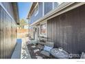 Side view of home featuring charming sitting area and walkway at 1055 Ponderosa Cir, Longmont, CO 80504