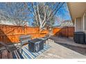 Cozy outdoor living space, with a patio set and a beautiful rug, surrounded by a wooden fence at 1215 Monarch Dr, Longmont, CO 80504