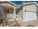 Inviting front entrance with a cozy porch and well-maintained exterior, painted with a neutral hue at 1215 Monarch Dr, Longmont, CO 80504