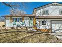 Inviting front porch with rocking chairs, natural wood accents, and a freshly painted exterior at 1317 S Terry St, Longmont, CO 80501