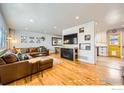 Open-concept living area with hardwood floors, stylish decor, and seamless access to the adjacent kitchen at 1317 S Terry St, Longmont, CO 80501