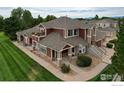 Attractive townhome showcasing its architecture and landscaping with a view of the surrounding area at 13722 Legend Way # 101, Broomfield, CO 80023