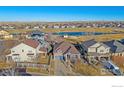 Aerial view of a suburban neighborhood featuring a pond and single-Gathering homes, creating a peaceful atmosphere at 1392 S Duquesne Cir, Aurora, CO 80018