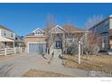 Inviting two-story home featuring a brick facade, attached garage, and well-maintained front yard at 1392 S Duquesne Cir, Aurora, CO 80018