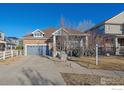 Beautiful two-story home featuring a brick facade, attached garage, and well-maintained front yard at 1392 S Duquesne Cir, Aurora, CO 80018