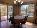 Cozy dining area with chandelier, and sliding glass doors to a porch with outdoor views and natural light at 15346 Heritage Cir, Thornton, CO 80602