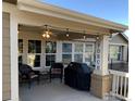 Relaxing covered porch with outdoor seating and string lights perfect for entertaining at 15346 Heritage Cir, Thornton, CO 80602