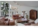 Bright living room with vaulted ceilings, multiple windows, and comfortable leather seating at 1866 Park Lake Dr, Boulder, CO 80301