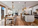 Bright and airy dining room with chandelier and modern open floor plan at 2342 Irons St, Erie, CO 80516