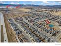 Aerial view of community near TPC Colorado Golf Course and Lonetree Reservoir with houses, roads, and parks at 2719 Tallgrass Ln, Berthoud, CO 80513