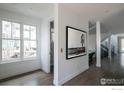 Hallway with hardwood floors, modern art, and access to other rooms at 3182 5Th St, Boulder, CO 80304