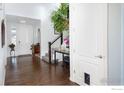 Inviting foyer with hardwood floors, a staircase, and a view of the front door at 3385 Birch Rd, Longmont, CO 80504