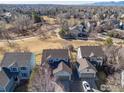 Aerial view of a neighborhood showcasing lush landscaping, walking trails, and mountain views at 4007 Sandcherry Pl, Longmont, CO 80503