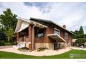 Traditional brick home featuring a manicured lawn and charming architectural details at 4100 Eliot St, Denver, CO 80211