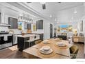 Open concept dining room and kitchen featuring modern appliances and stylish lighting at 450 S Decatur St, Denver, CO 80219