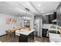 Modern kitchen featuring stainless steel appliances, an island with seating, and pendant lighting at 450 S Decatur St, Denver, CO 80219