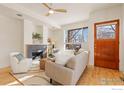 Inviting living room with a modern fireplace, large window, and hardwood floors at 4653 14Th St, Boulder, CO 80304