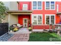 Charming covered front porch with seating and decorative plants, creating an inviting entryway for this colorful home at 4714 16Th St, Boulder, CO 80304