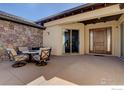 Cozy outdoor patio with stone accents offers an inviting space for gatherings and enjoying the outdoors at 4822 Bandera Pl, Parker, CO 80134