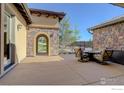 Charming outdoor patio features a stone archway and comfortable seating, perfect for relaxing and entertaining at 4822 Bandera Pl, Parker, CO 80134