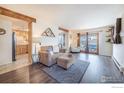 Open living room featuring hardwood floors, a cozy seating area, and natural light at 491 S Dover Ave, Lafayette, CO 80026