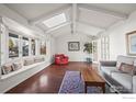 Bright living room with hardwood floors, skylight, and a large bay window at 5266 Gallatin Pl, Boulder, CO 80303