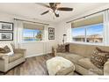 Comfortable living room featuring large windows with water view and neutral decor at 5425 County Road 32 # 13, Mead, CO 80504