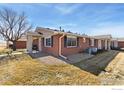 View of single-story home, showing brick exterior, gutters and manicured lawn at 5425 County Road 32 # 13, Mead, CO 80504