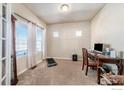 Bright office space with a treadmill, desk, and chair set up under natural lighting with neutral walls and carpet flooring at 5482 Wetlands Dr, Frederick, CO 80504