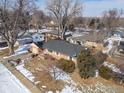 An aerial view of the property showcasing its location, brick exterior, roof, and surrounding neighborhood at 6 Sunset Cir, Longmont, CO 80501