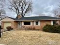 Lovely single-story brick home with a well-kept lawn and inviting porch, perfect for enjoying the outdoors at 6 Sunset Cir, Longmont, CO 80501