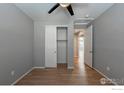 An empty bedroom painted gray with light wood floors and an open closet at 6121 Easton Cir, Frederick, CO 80504