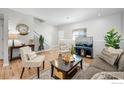 Bright living room with a staircase, comfortable seating, and a view of the outside through the window at 6343 E Ohio Ave, Denver, CO 80224