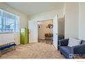 Cozy bedroom with neutral carpet, a large window, and access to another room at 7231 Clarke Dr, Frederick, CO 80530