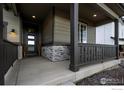 Inviting front porch featuring stone accents, decorative lighting, and a modern front door at 744 S 10Th St, Berthoud, CO 80513