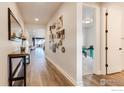 Bright hallway featuring wood floors and tasteful wall decor, leading to other rooms at 744 S 10Th St, Berthoud, CO 80513